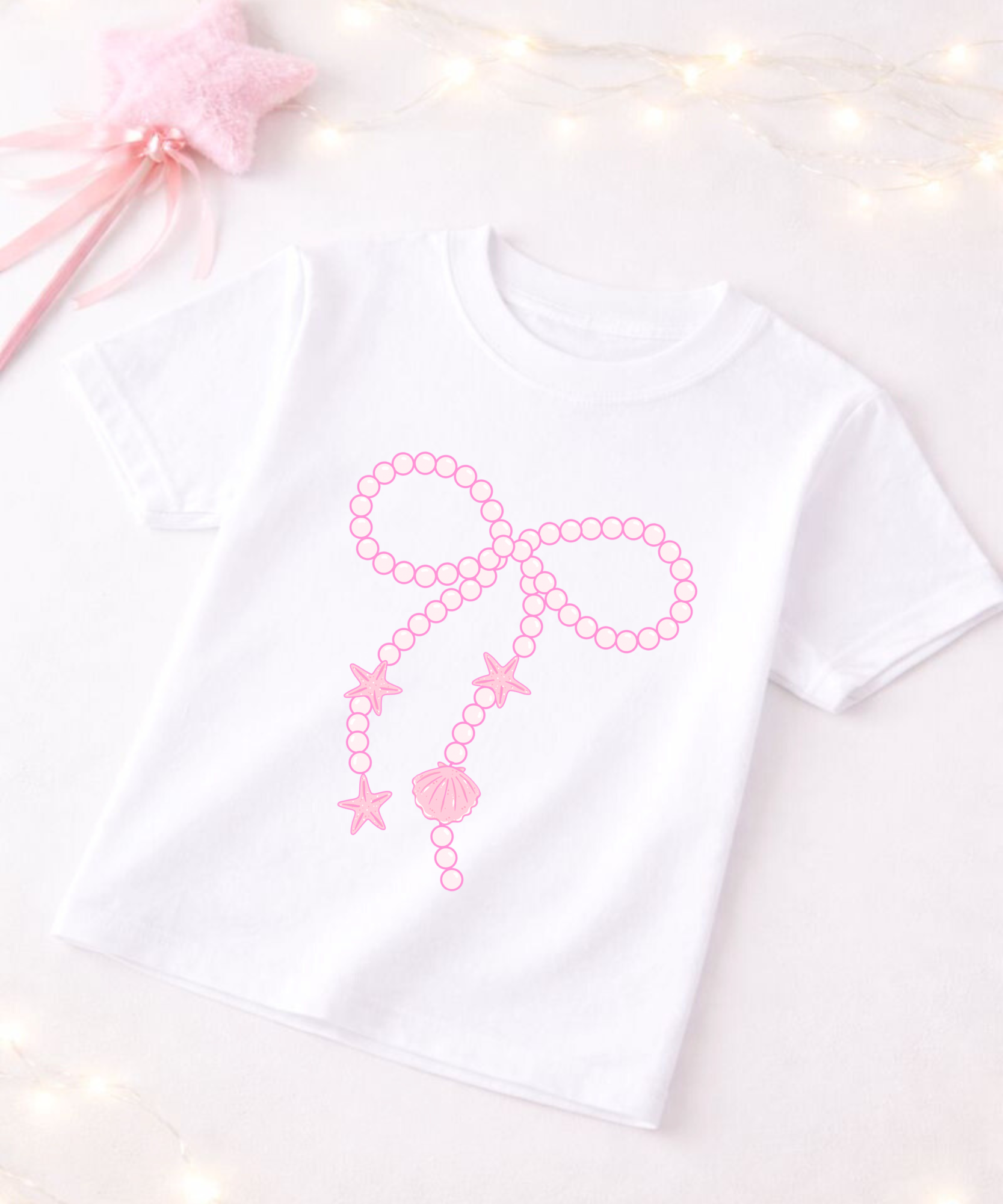 White t-shirt with pink decorative design on a light background